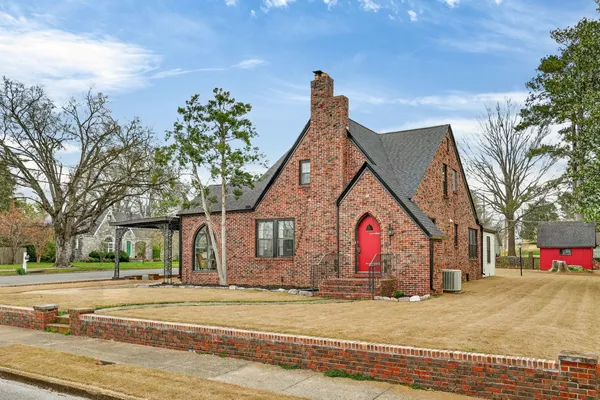 a view of a house with a yard and garage
