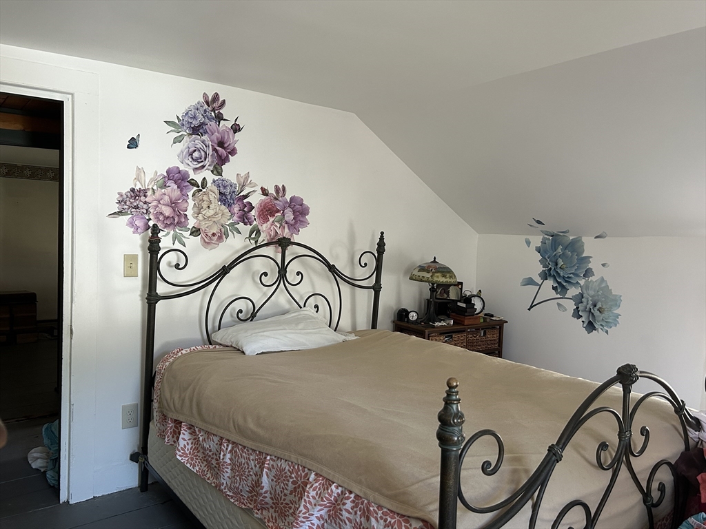 11 Maple Street Chester, MA 01011 - Photo 15 of 28 a bedroom with a bed and a table with potted plants