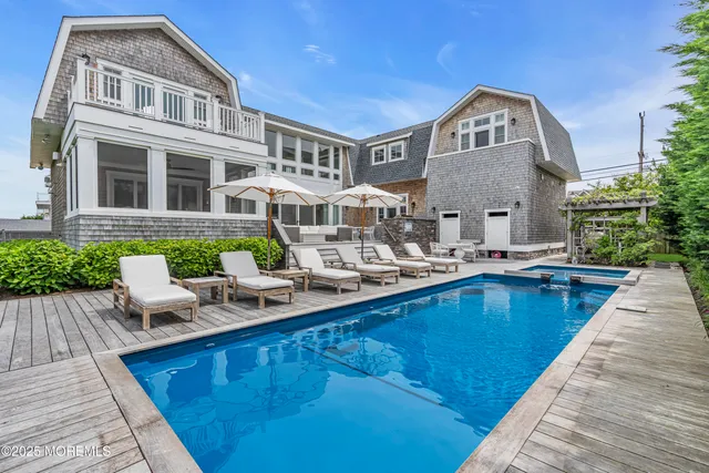 a view of a house with swimming pool and sitting area