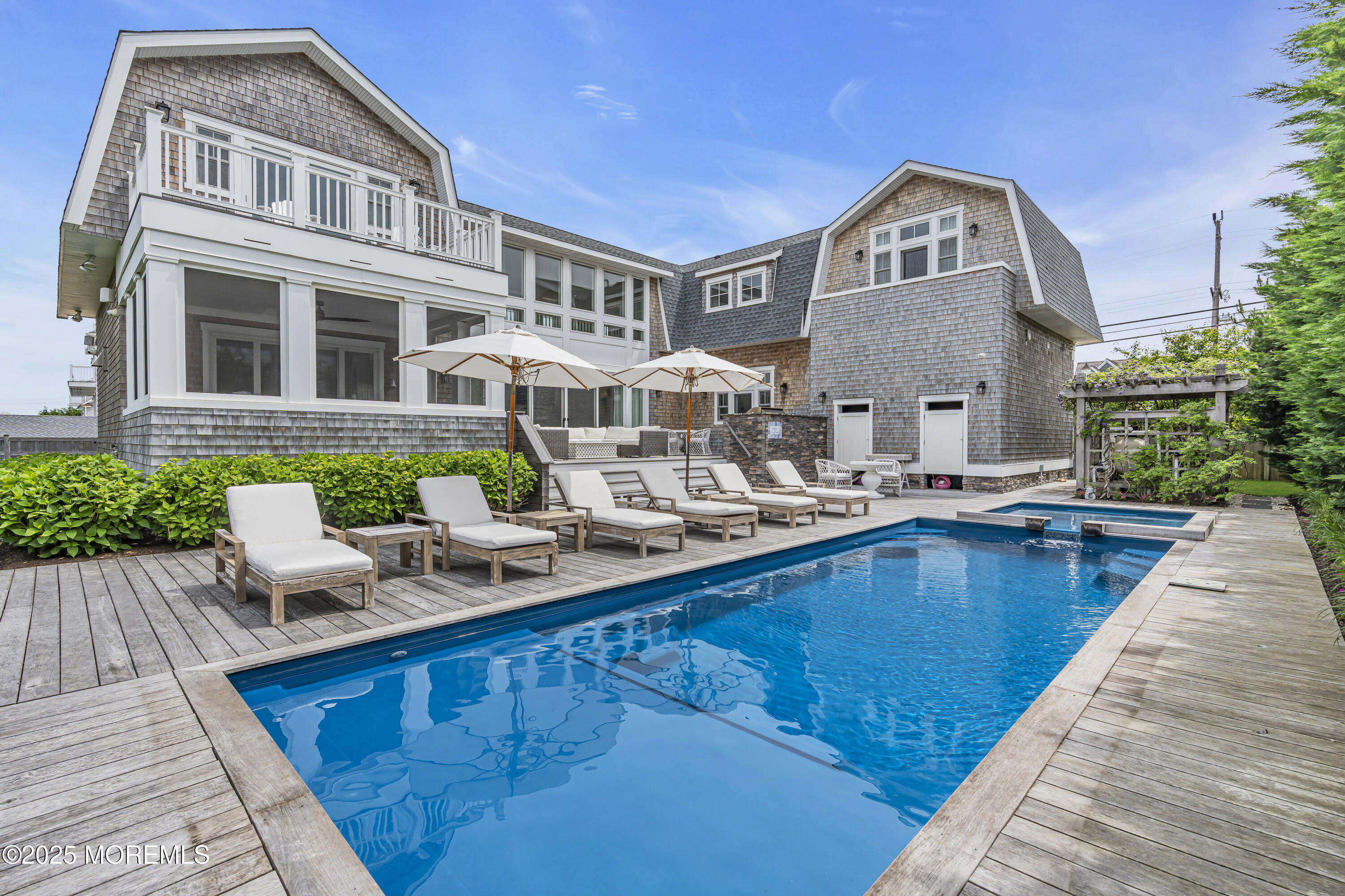 a view of a house with swimming pool and sitting area