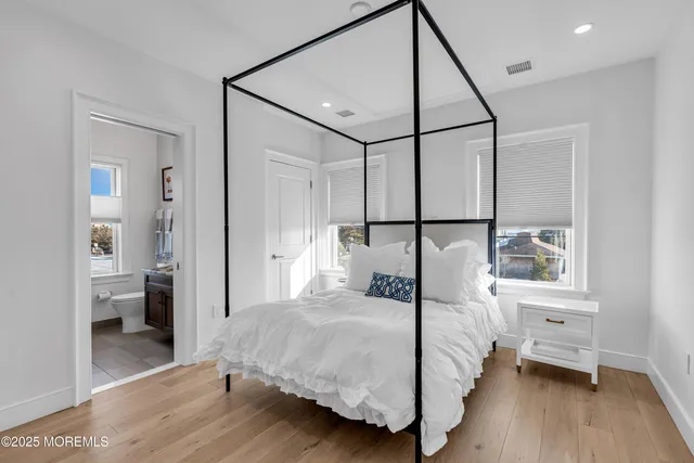 a bedroom with a bed and a mirror