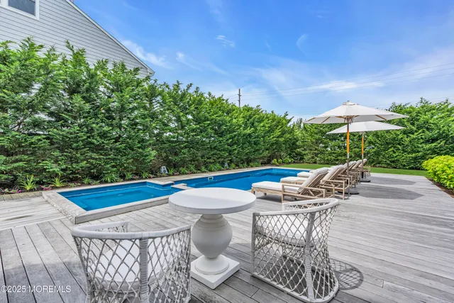 a view of outdoor sitting area with furniture and wooden floor