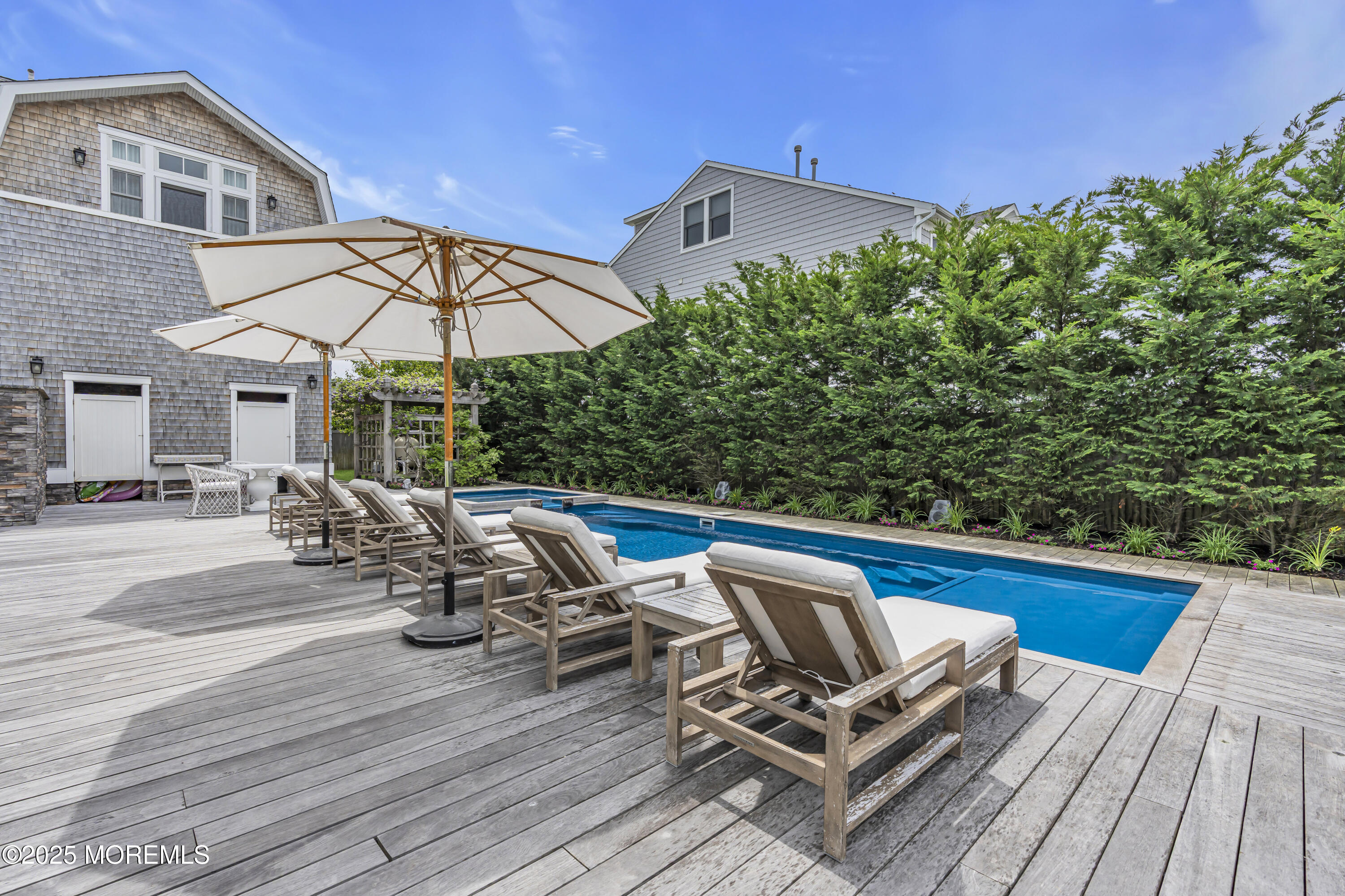 135 Highway 35 Mantoloking, NJ 08738 - Photo 26 of 36 a view of a roof deck with table and chairs under an umbrella with wooden floor