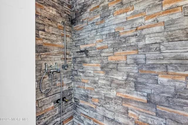 a view of a yard with plants and a large tree