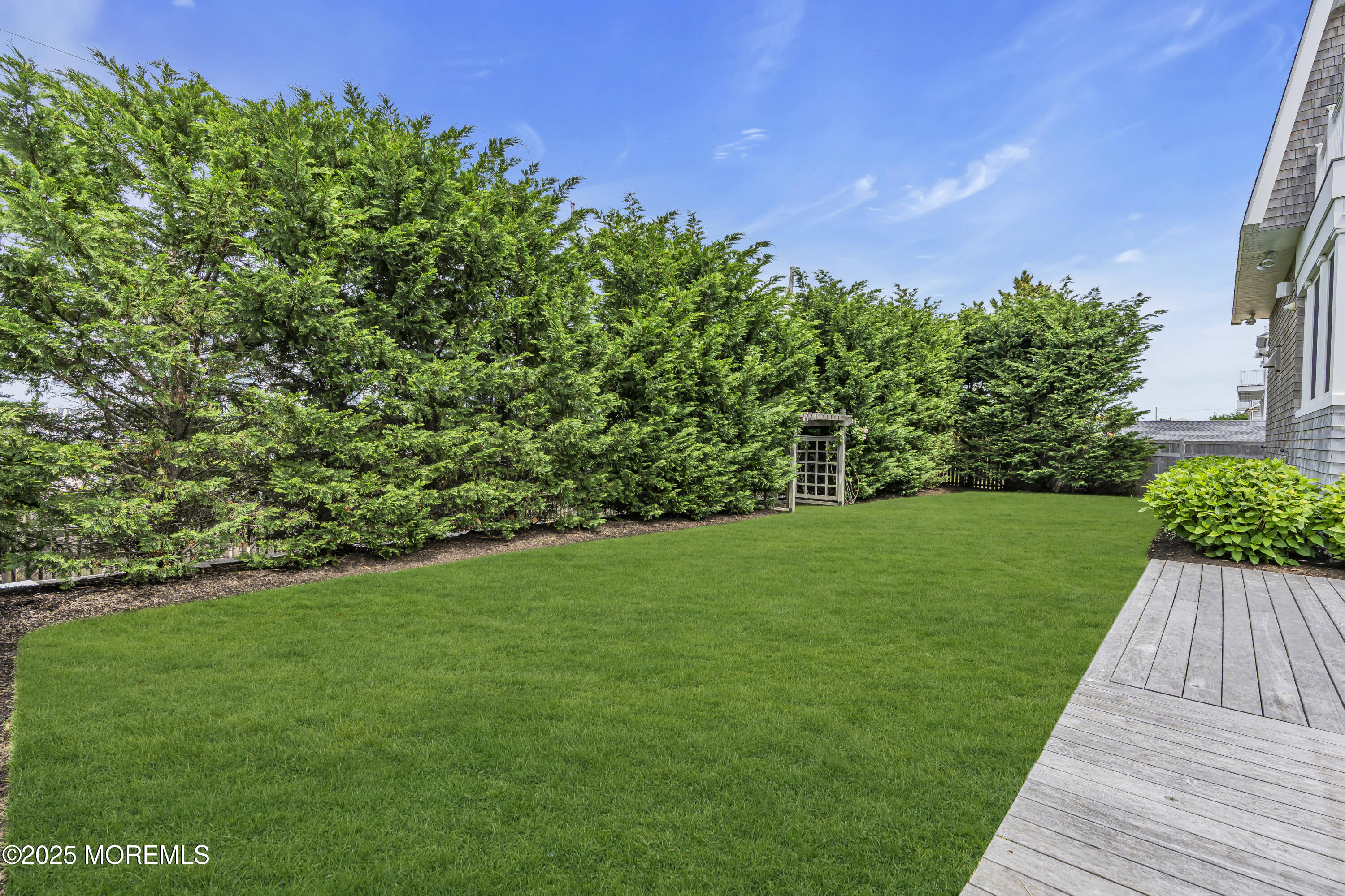 135 Highway 35 Mantoloking, NJ 08738 - Photo 31 of 36 a view of a yard with plants and a large tree