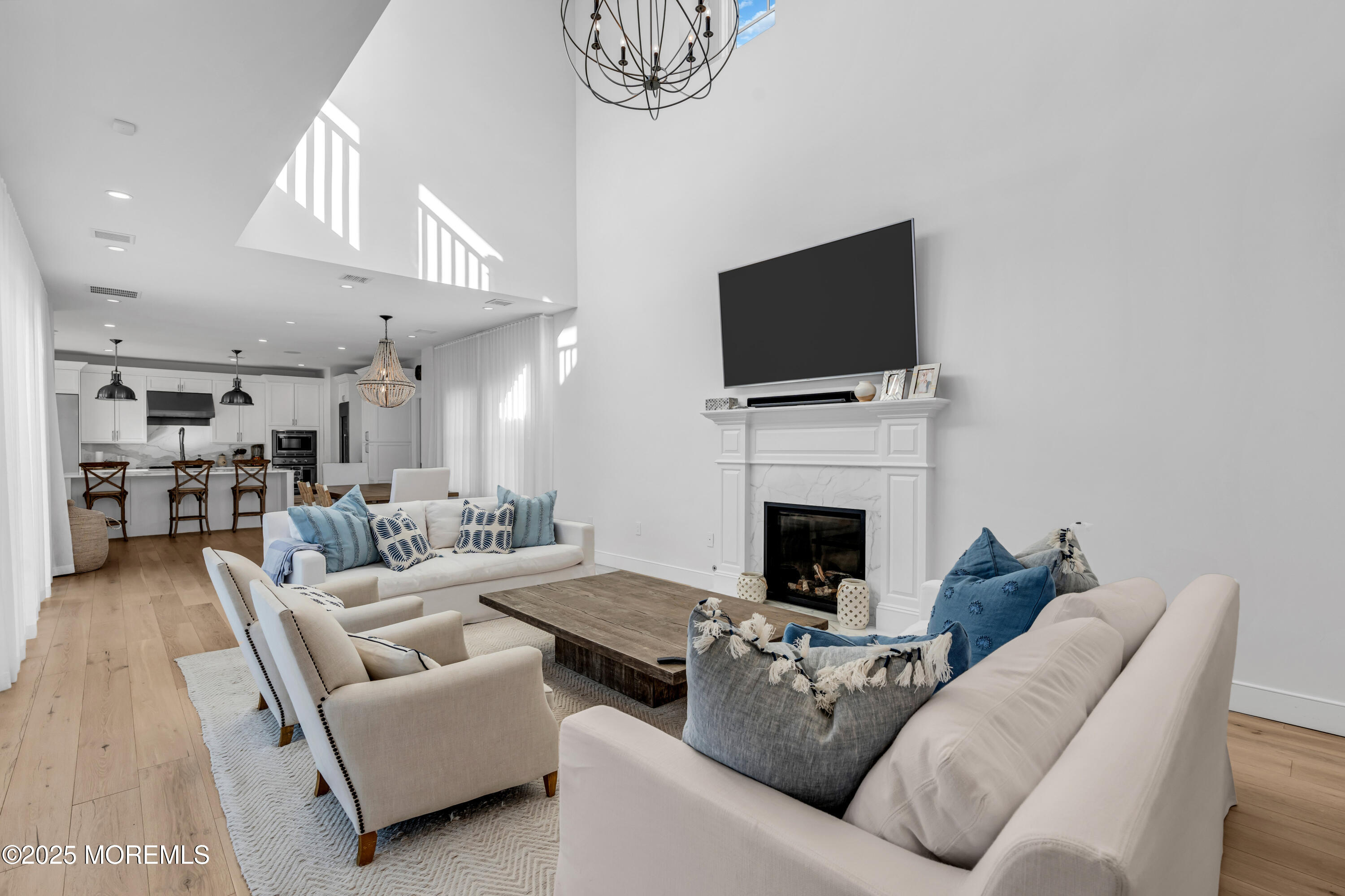 135 Highway 35 Mantoloking, NJ 08738 - Photo 5 of 36 a living room with furniture a flat screen tv and a fireplace