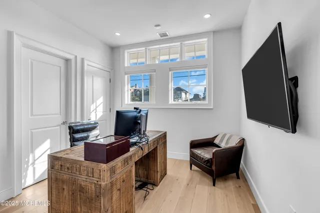 a view of a workspace with furniture and a window