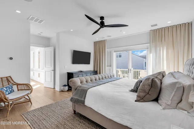 a bedroom with a bed couch and window