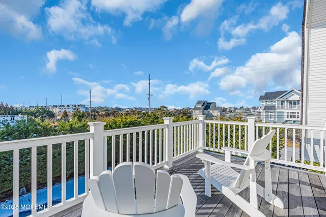 a view of a chair and table on the roof deck