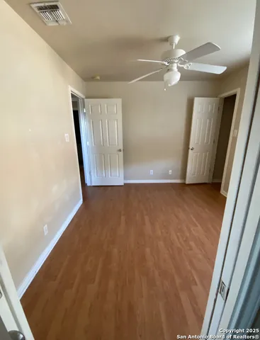 a view of a room with wooden floor and staircase