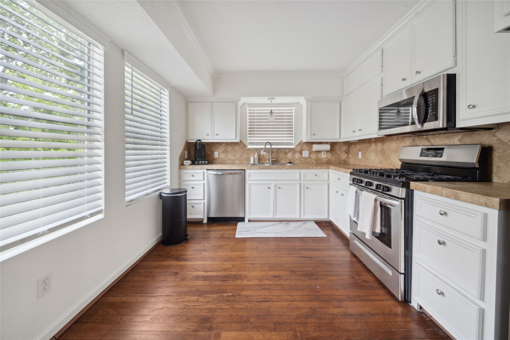 1105 Tulane Street, Unit B Houston, TX 77008 - Photo 8 of 24 a kitchen with stainless steel appliances granite countertop a stove top oven a sink dishwasher and a refrigerator
