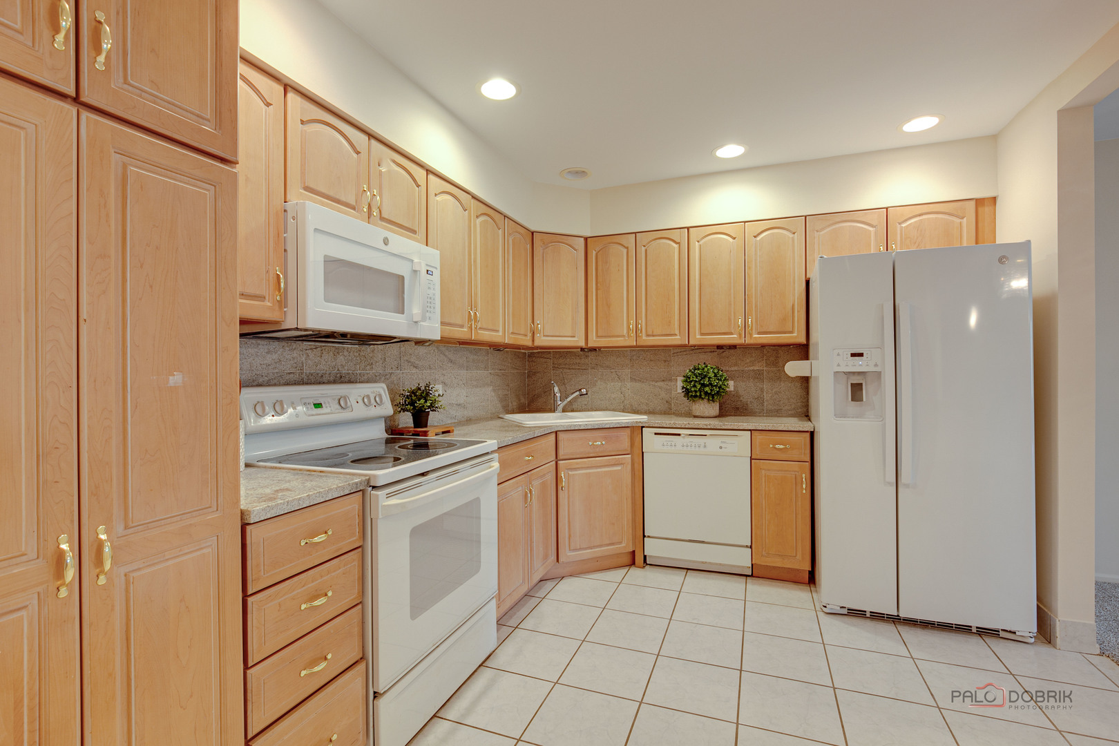 1088 Shermer Road, Unit 307 Northbrook, IL 60062 - Photo 7 of 35 a kitchen with white cabinets stainless steel appliances and a sink