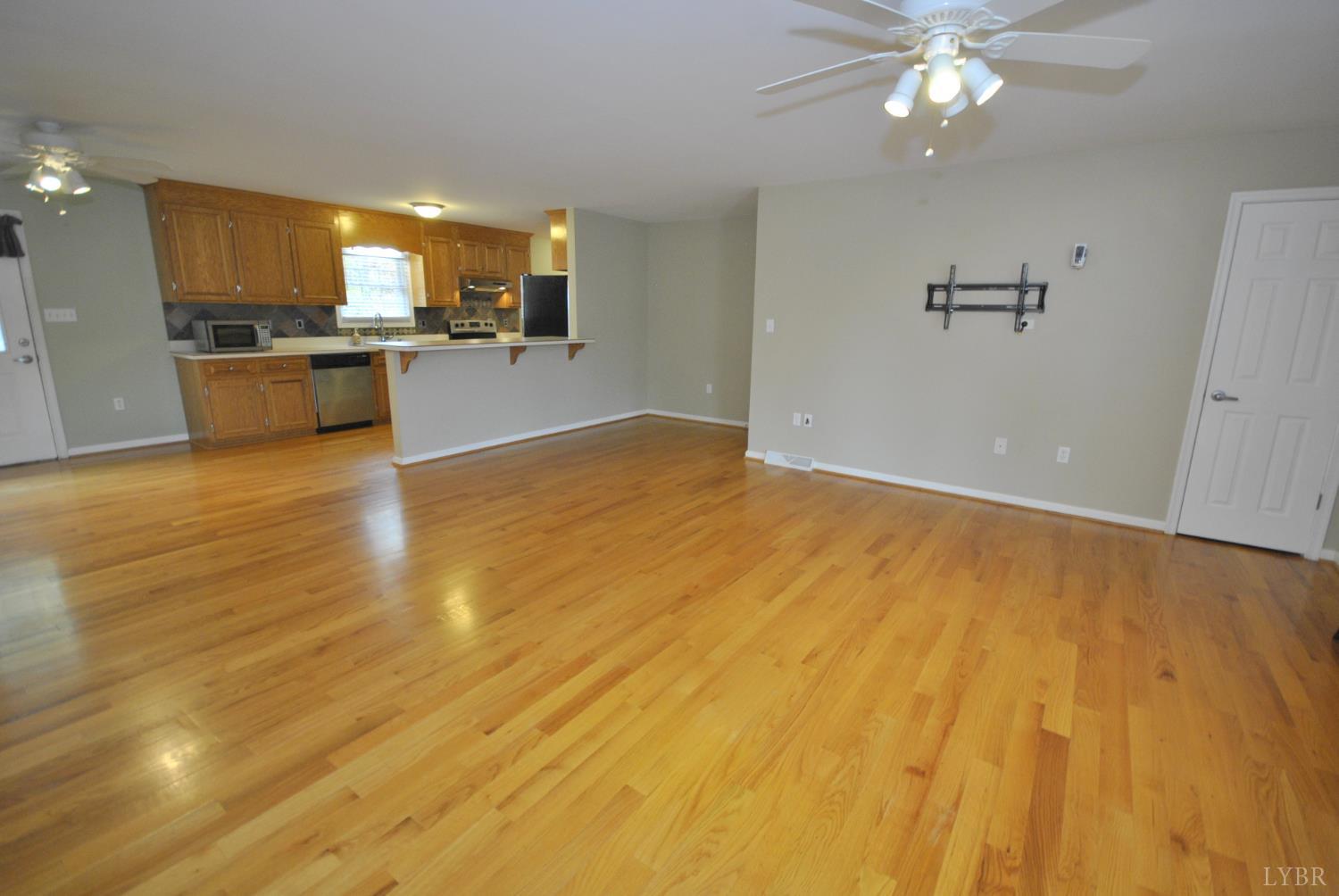 a view of a kitchen with a stove cabinets and wooden floor