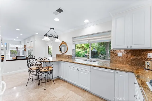 a view of walk in closet with clothes