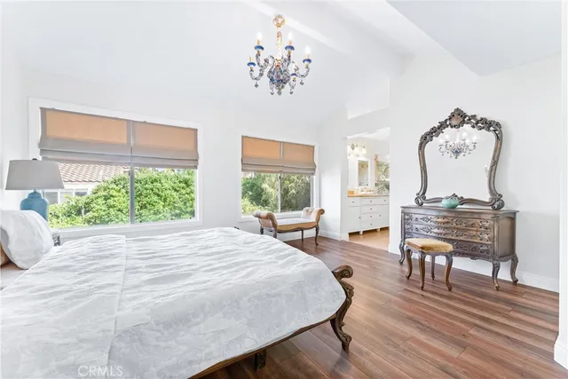 a bedroom with a bed and a chandelier