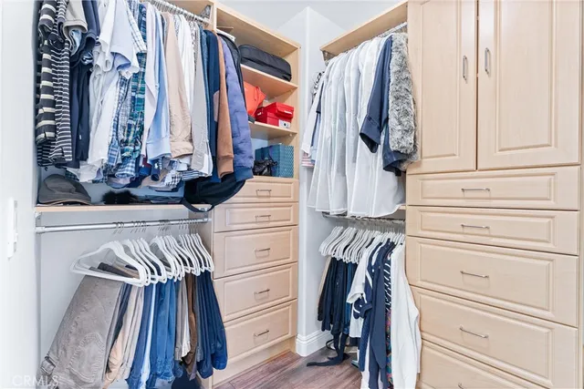 a view of a bedroom with wooden floor and windows