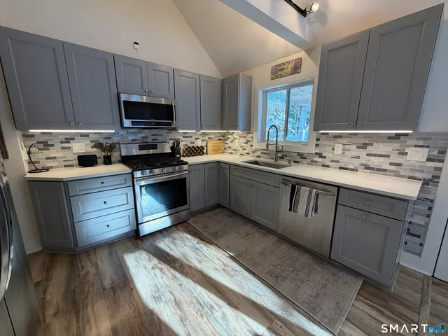 a kitchen with a sink stove and cabinets