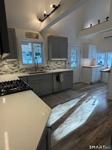 a kitchen with stainless steel appliances a sink and a stove