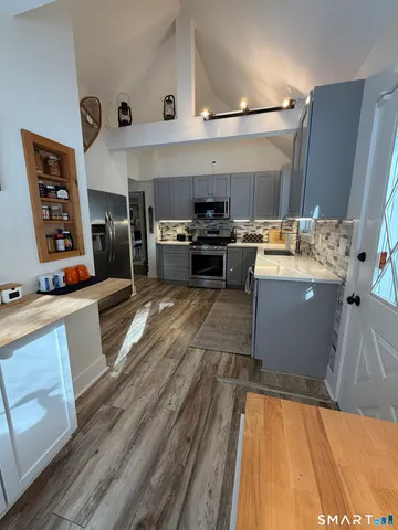 a kitchen with a sink dishwasher stove and refrigerator