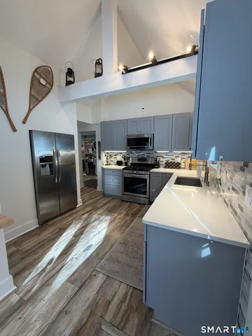 a kitchen with a sink appliances and cabinets
