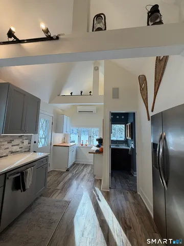 a kitchen with stainless steel appliances granite countertop a stove refrigerator and cabinets