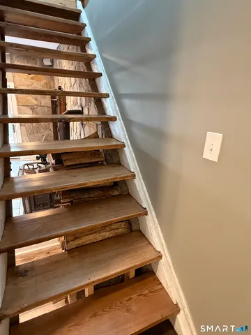a view of staircase with white walls and a window