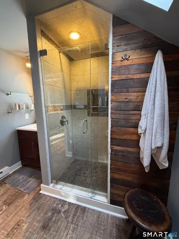 a bathroom with a glass shower door
