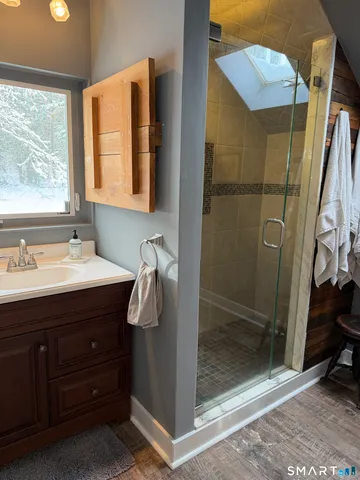 a bathroom with a sink a mirror and shower