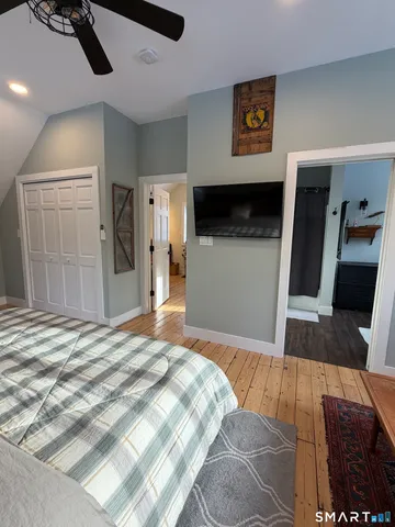 a bedroom with a bed and a television on desk