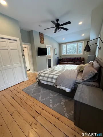 a bedroom with a bed and a mirror