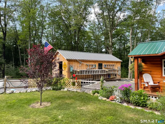 a backyard of a house with table and chairs