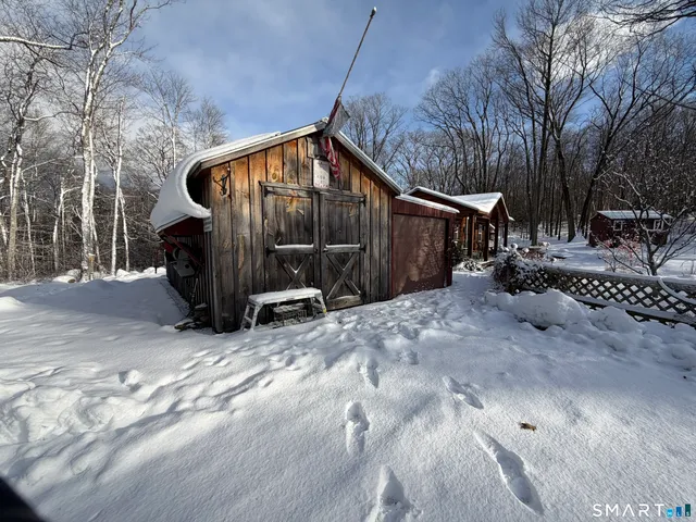a view of a barn in the middle of a yard