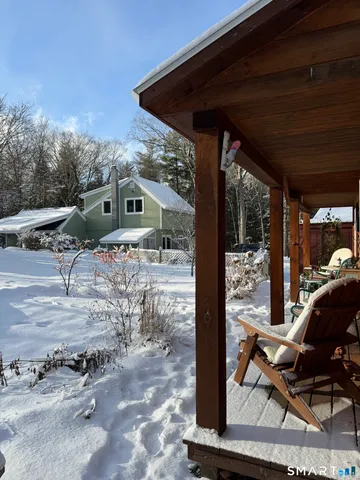 a view of a patio with a table and chairs under an umbrella