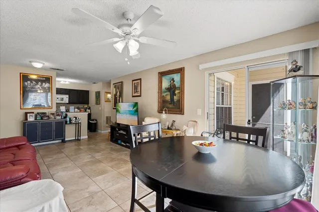 a living room with furniture and kitchen view