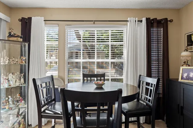 a view of a dining room with furniture window and outside view