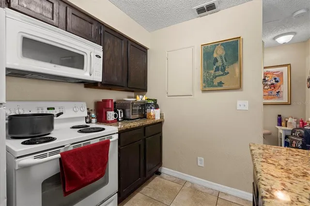 a kitchen with stainless steel appliances granite countertop a stove a microwave and cabinets
