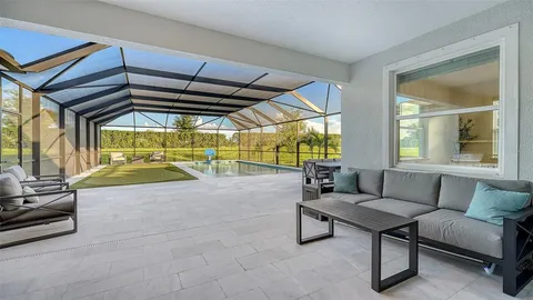a kitchen with stainless steel appliances granite countertop a white table and chairs