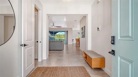 a view of a hallway with wooden floor and entryway