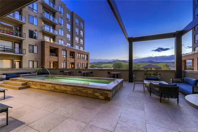 a view of a patio with a table and chairs