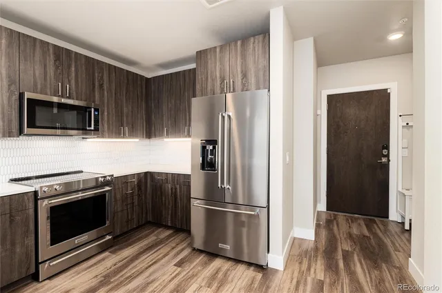 a kitchen with a stove microwave and refrigerator
