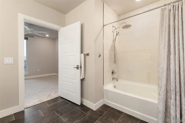 a bathroom with a bathtub and a shower