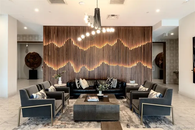 a living room with couches a coffee table and a fireplace with garden view