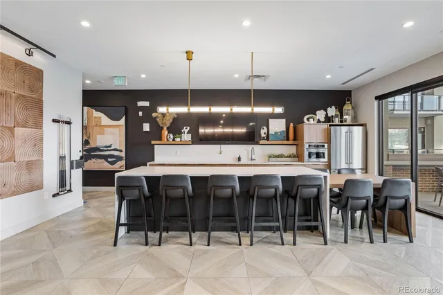 a large kitchen with a table and chairs
