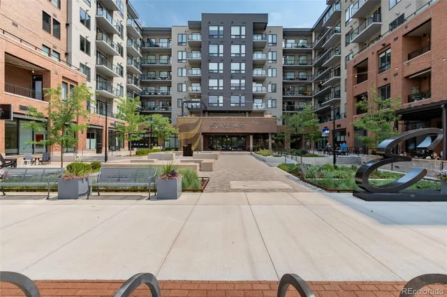 a swimming pool with outdoor seating area and view of building