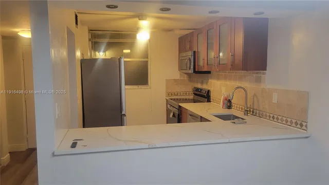 a kitchen with a sink and a refrigerator