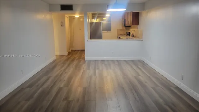 a view of hallway with wooden floor