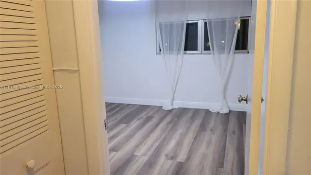 a view of walk in closet with clothes