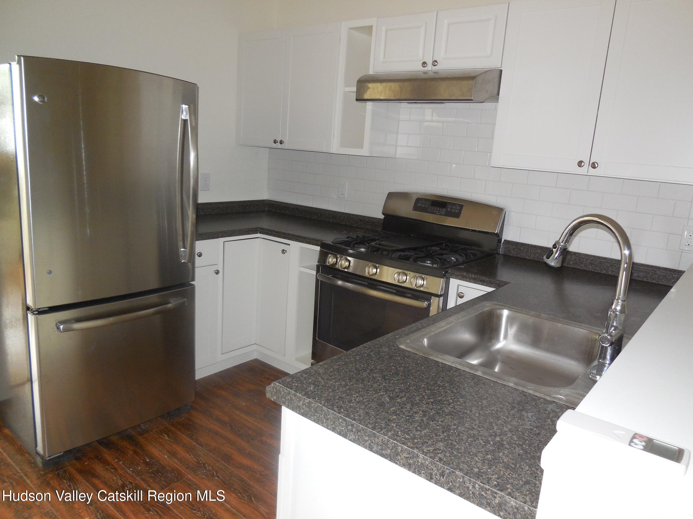 431 Warren Street, Unit 2 Hudson, NY 12534 - Photo 5 of 6 a kitchen with a refrigerator stove and sink