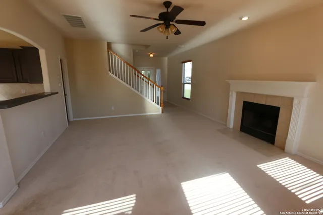 a view of entryway and hall with a fireplace
