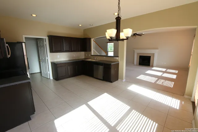 a kitchen with stainless steel appliances granite countertop a refrigerator a oven a sink and a oven